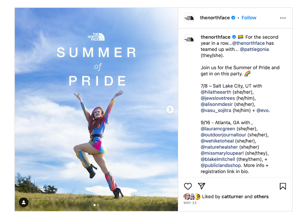 A post from The North Face instagram showing drag queen Pattie Gonia wearing a short rainbow dress with platform boots, with her hands in the air, under the heading 'Summer of Pride'